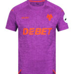 Purple athletic jersey with orange 'DEBET' sponsor across the chest, orange wolf crest on the left chest, and small logos on the shoulders; purple patterned fabric.