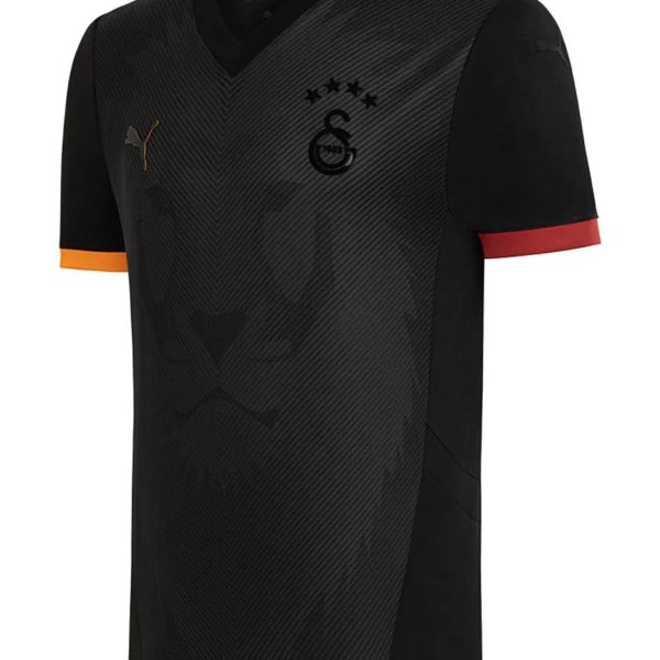 Black and charcoal soccer jersey with diagonal pattern, team crest and four stars, Puma logo on chest.