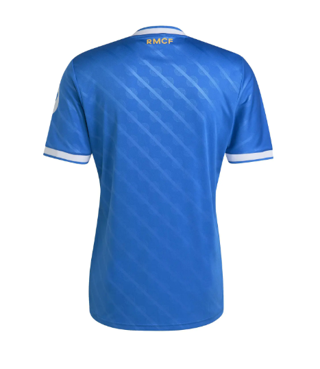 Back view of a bright blue soccer jersey with diagonal lighter stripes, white sleeve cuffs, and 'RMCF' at the collar.