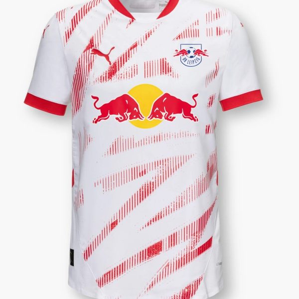 White RB Leipzig soccer jersey with red diagonal stripe pattern, red collar trim, and large Red Bull logo across the chest, plus club crest on the left.