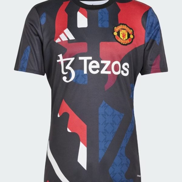 Manchester United football jersey featuring Tezos sponsor and red-blue abstract patterns with club crest on the chest