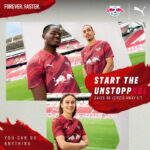 MDMi6VvYp5opj4V | UAE SPORT STORE RB Leipzig players in maroon away kit posing on a stadium pitch with a bold red brush-stroke banner reading 'Start the Unstoppable'.