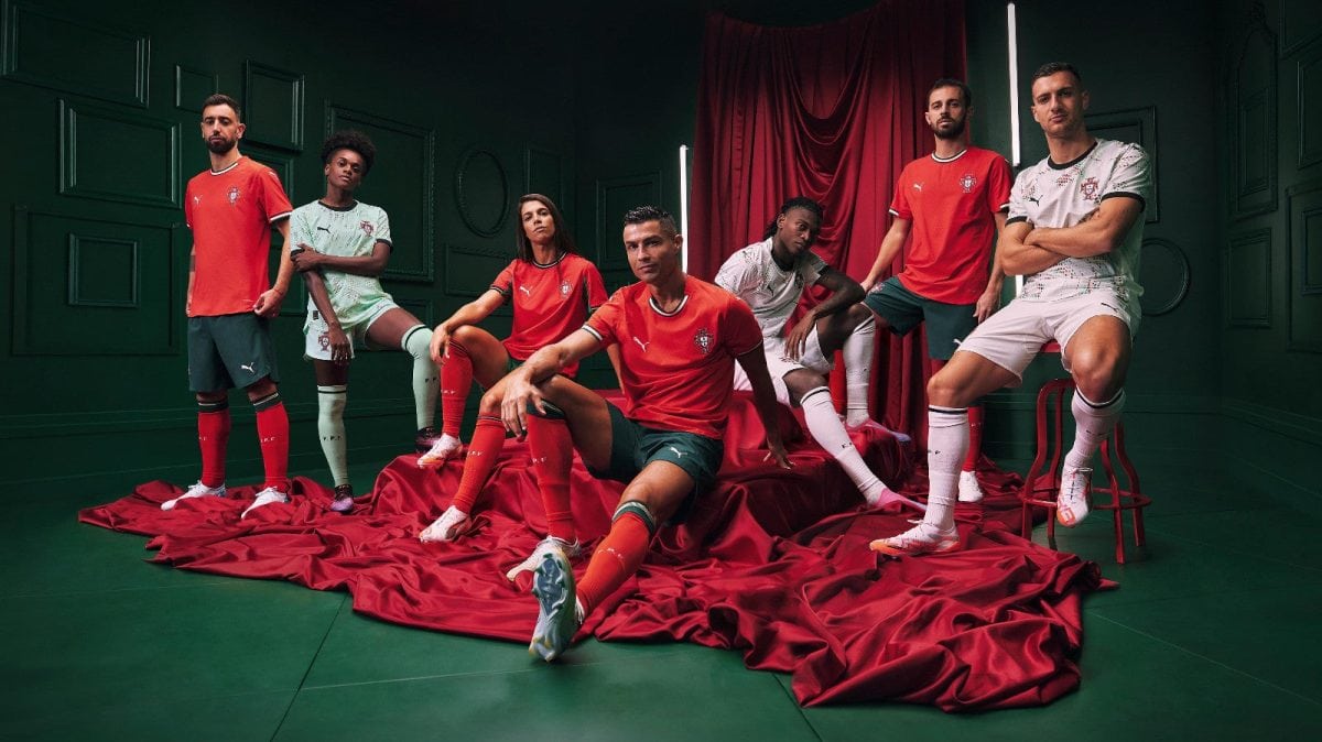 Portugal national team players pose in a studio with green walls and red drapery, wearing red and white kits.