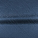 Close-up of blue woven fabric with diagonal lines and subtle texture.