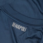 Close-up of a navy blue SSC Napoli jersey showing the white 'SSC NAPOLI' branding near the collar.