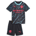 Dark blue football jersey with turquoise lightning pattern and collar, pink Etihad Airways sponsor, club crest, and Puma logos, paired with matching dark shorts featuring crests and Puma logo.