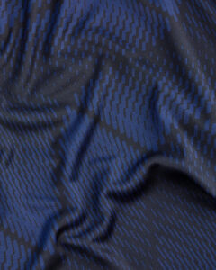 Close-up of dark blue fabric with a repeating blue dash pattern and subtle sheen.