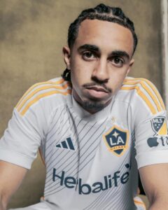 MtI0ih8vPhKsZ09 | UAE SPORT STORE Close-up portrait of a young man in an LA Galaxy jersey looking at the camera.