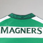 Back of a green and white sports jersey with large 'MAGNERS' lettering across the back collar area.