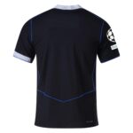 Back of a black soccer jersey with blue piping and white collar detail, displaying a UEFA patch on the sleeve.