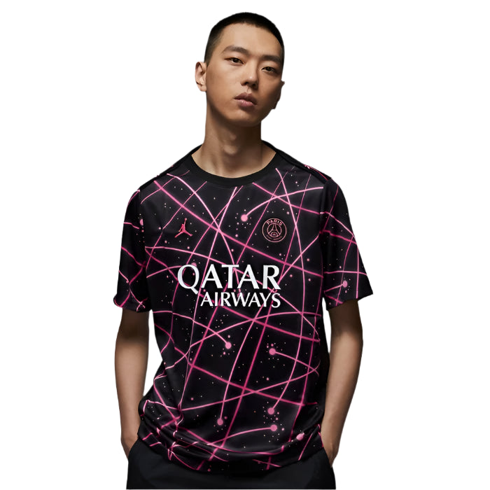 NK_NKIF3971_011_198480156758_1 Young man wearing a black soccer jersey with pink neon grid patterns and the 'QATAR AIRWAYS' logo on the front.