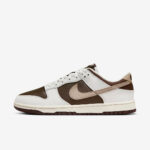 Nike Dunk Low sneaker in white and brown leather with a beige swoosh, side view on a white background