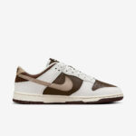 Nike Dunk-style sneaker in white, brown, and beige with leather panels and a beige swoosh on the side