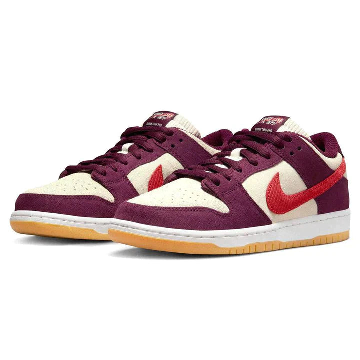 Nike-SB-Dunk-Low-Skate-Like-a-Girl-2_720x_47b57dd2-764c-4936-a60c-f7fd8c630bb8 | UAE SPORT STORE Pair of purple and cream sneakers with a red Nike Swoosh, shown from the side with gum-colored outsoles.