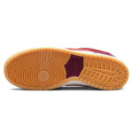 Nike-SB-Dunk-Low-Skate-Like-a-Girl-5_720x_e13018f0-402a-4f58-9e1e-e97b8d573607 | UAE SPORT STORE Outsole of a red sneaker with a tan rubber sole and circular grip pattern at the toe and a grid-like pattern along the middle and heel