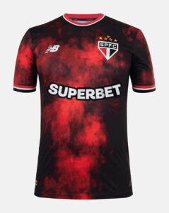 Red and black gradient football jersey with SPFC crest, New Balance logo, and 'SUPERBET' sponsor across the chest on a red smoky pattern background.