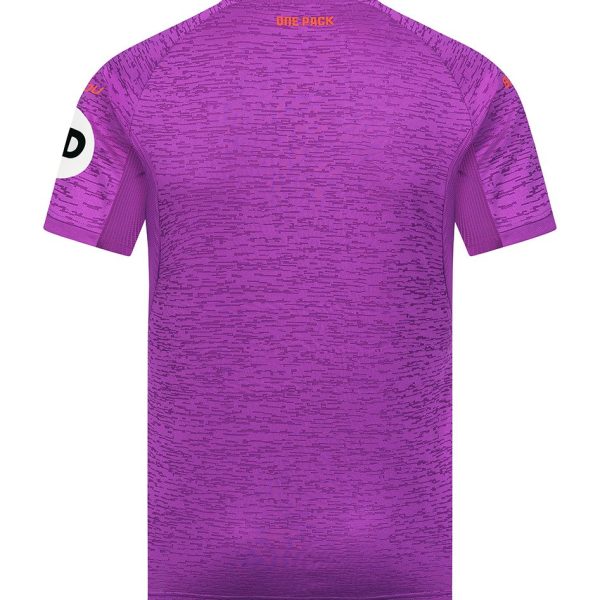 Purple athletic jersey back view with a subtle horizontal pattern, short sleeves, orange 'ONE PACK' text at the neckline, and a white circular patch with a letter on the left sleeve