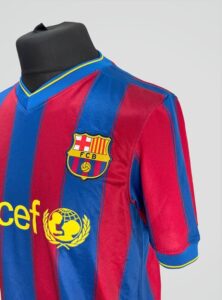 Barcelona FC soccer jersey on a display form, blue and red vertical stripes, club crest on left chest, UNICEF sponsor logo in yellow on front