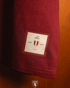 Close-up of maroon fabric with a square commemorative patch: 75 Superga, Italian flag shield, years 1949–2024, Torino FC logo below.