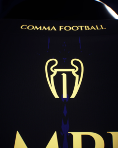 Close-up of a dark surface with gold text 'COMMA FOOTBALL' and a yellow trophy emblem.