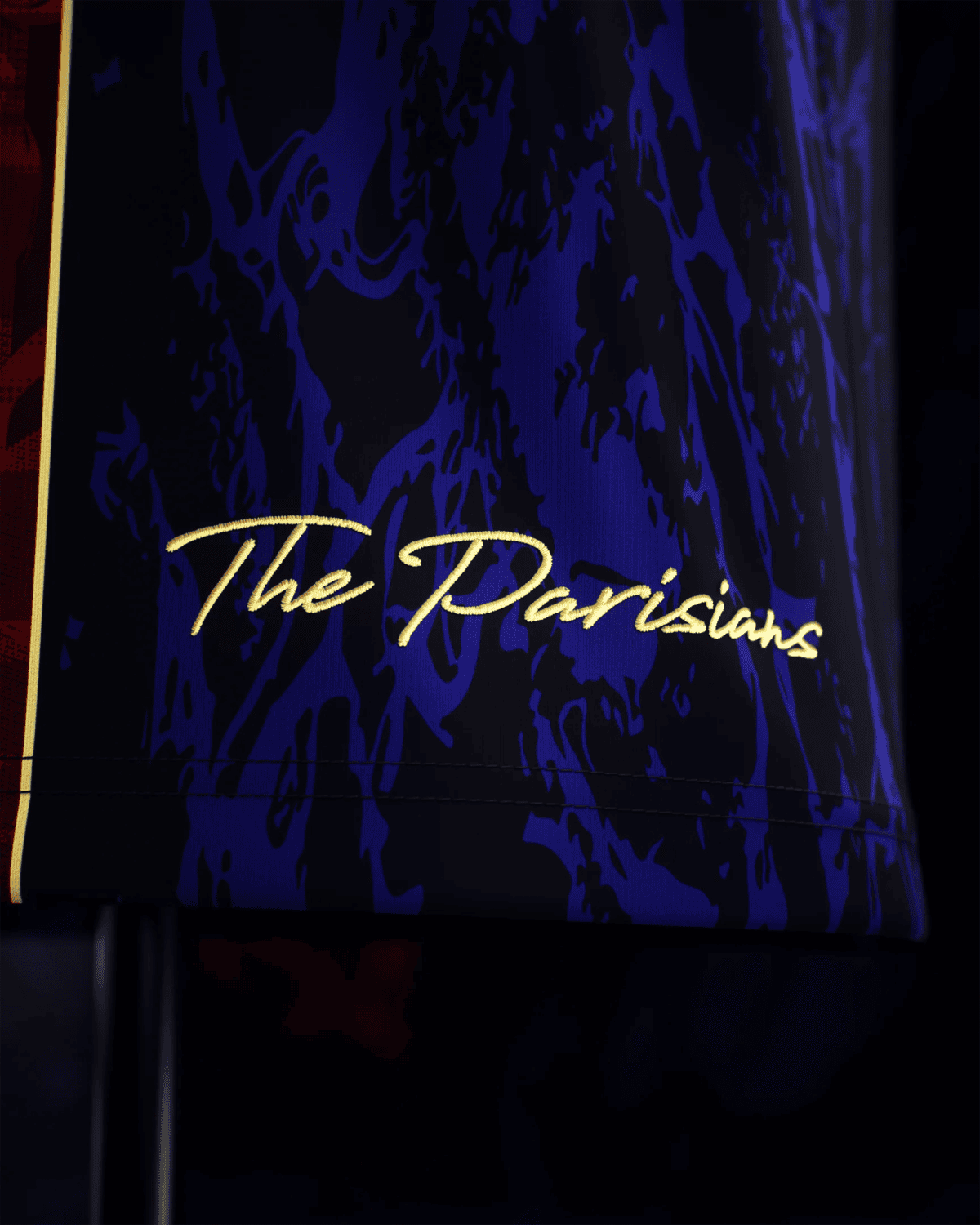 Close-up of a dark blue patterned surface with gold cursive script along the bottom edge.