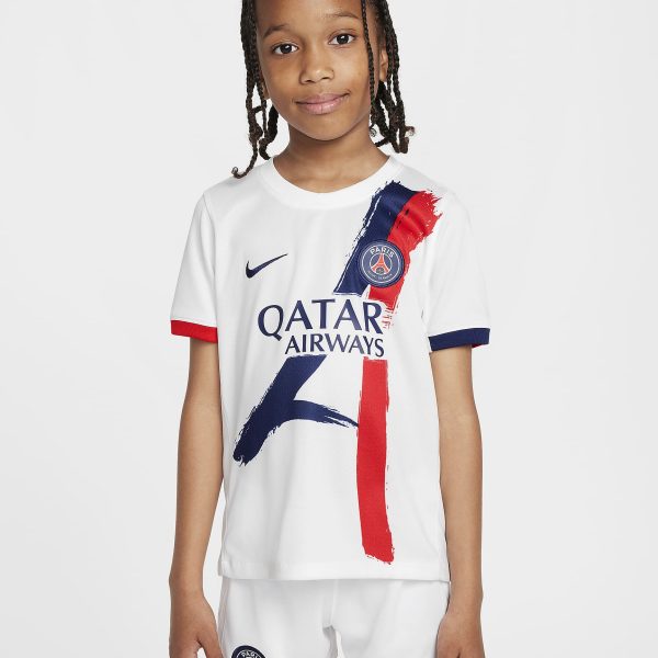 Smiling girl wearing a white Paris Saint‑Germain football jersey with red and blue brushstroke graphics and crest on the chest.