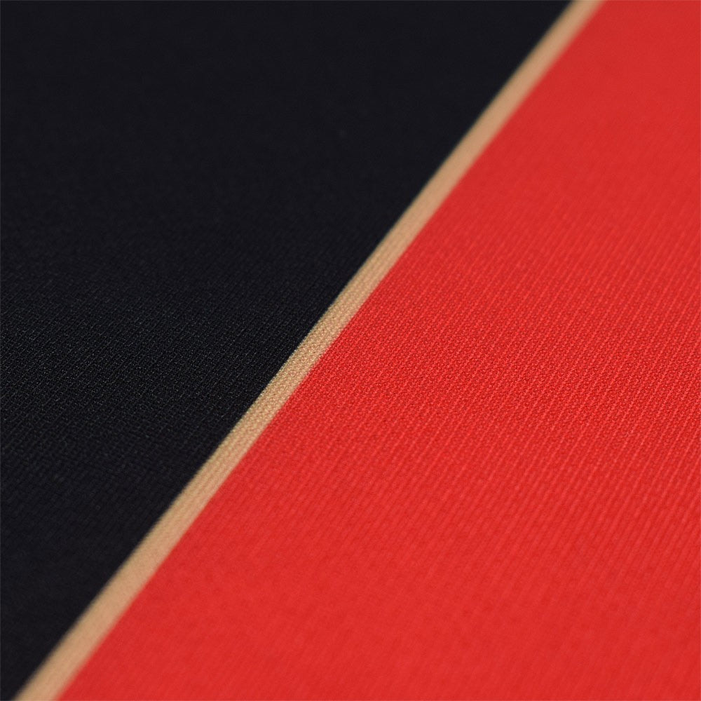 PdFmnGAq1c8iNlr | UAE SPORT STORE Close-up of black and red fabric with a thin beige seam between them.