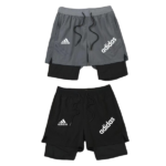 Two Adidas athletic shorts, gray over black with inner layer, featuring white Adidas logos and drawstrings.