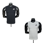 Two Nike sleeveless gym shirts on black mannequins: one black and one light gray/white, each with a small swoosh logo on the chest.