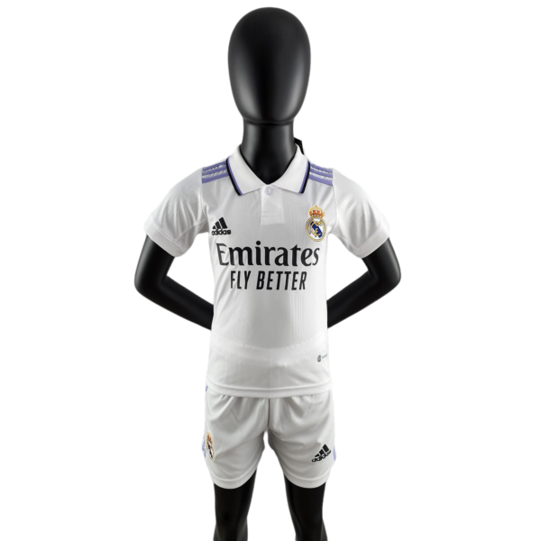 Black mannequin torso wearing a Real Madrid white away jersey with Emirates sponsor, facing forward.