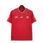 Red athletic jersey on a dark wooden hanger, featuring white stripes across the chest and Swiss flag patch; visible Puma branding and DryCell text.