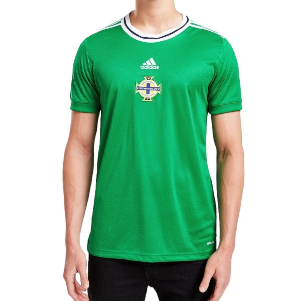 Man wearing a green Adidas Ireland national football team jersey with crest, standing against a white background.