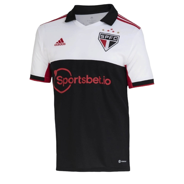White and black São Paulo FC soccer jersey with red accents: crest on the left chest, Adidas logo on the right, red sponsor text 'Sportsbet.io' across the midsection, and red trim on the sleeves and collar.