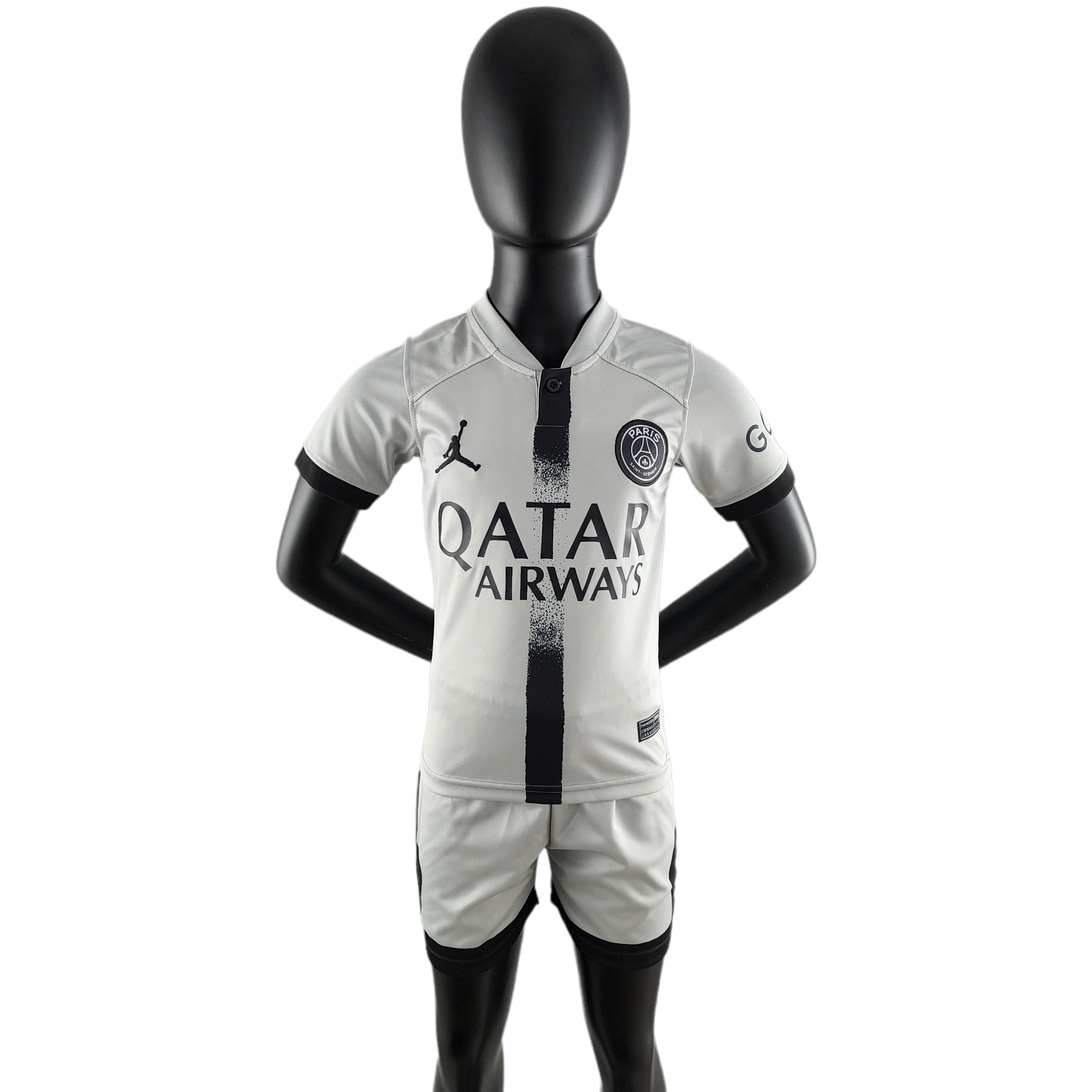PhotoRoom-20220923_193202_000167e7-e894-4143-87ec-34f87f3ca1de Black mannequin wearing a light gray Paris Saint-Germain football jersey with Qatar Airways sponsor and a black vertical stripe down the center.