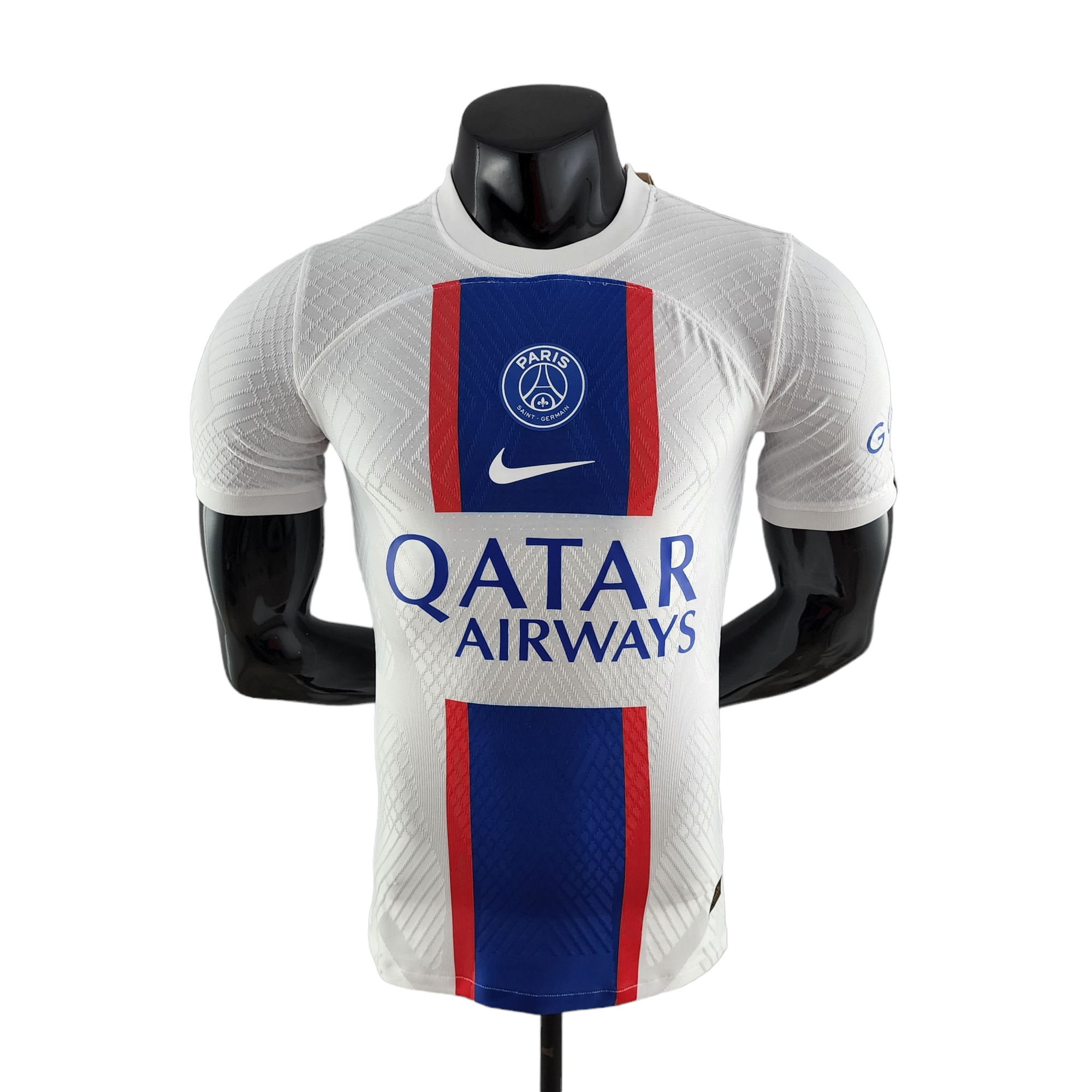 PhotoRoom-20221011_154011_9e5d0415-19a4-4190-8408-8a24f2f478cb White Paris Saint-Germain jersey on a mannequin with blue-red vertical stripe and Qatar Airways sponsor logo at chest height