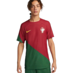 Male soccer player wearing Portugal national team jersey with a red and green diagonal design, featuring a yellow Nike swoosh and the Portugal crest.