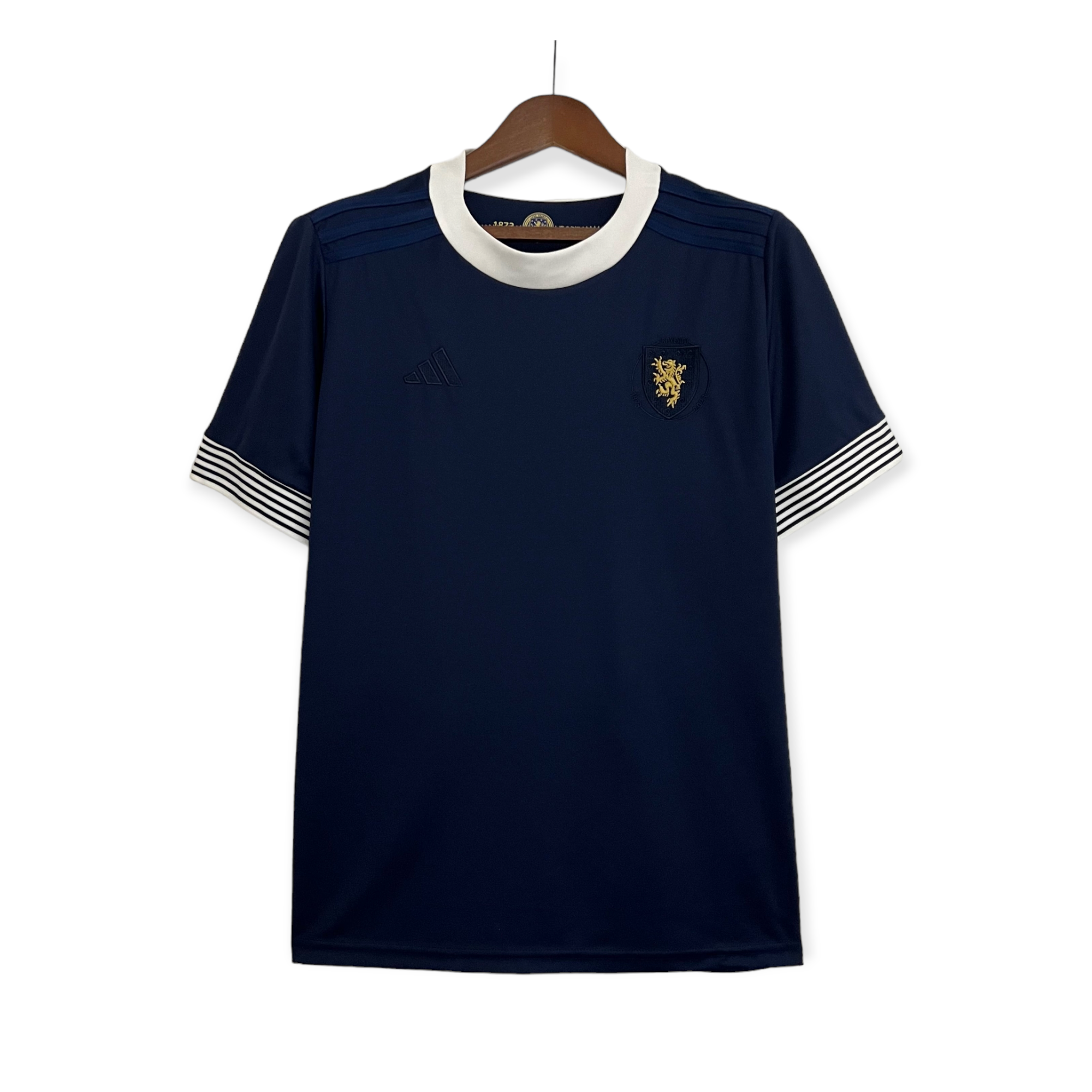 PhotoRoom-20230331_201748_e50c4a59-34f6-40f7-99e4-e1cbbc1779da Navy blue dress on a hanger with a white rounded collar and striped white cuffs at the sleeves, front view with crest badge on the chest area.