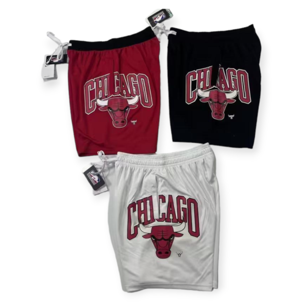 Athletic set with Chicago Bulls red shorts and black shirt featuring a bull logo laid flat with tags visible