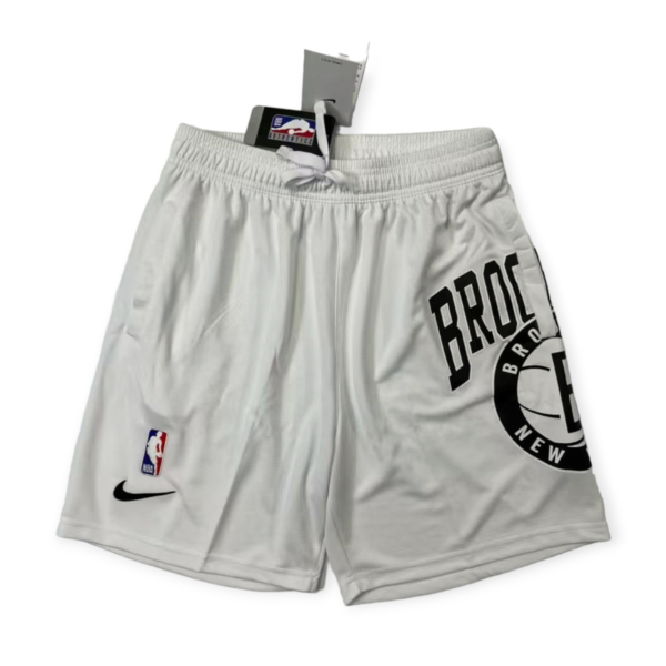 Gray athletic shorts with a white drawstring, featuring an NBA logo patch and a Nike swoosh visible near the hem.