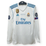 Real Madrid white football jersey with blue shoulder stripes, FIFA badge, and 'Final Kyiv 2018' text on the chest.