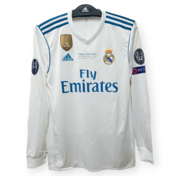Real Madrid white football jersey with blue shoulder stripes, FIFA badge, and 'Final Kyiv 2018' text on the chest.