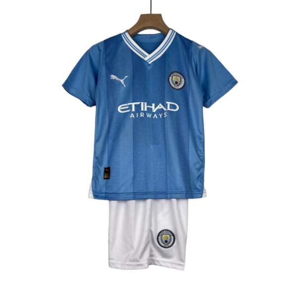 Blue Manchester City football jersey on hanger, features club crest, Puma logo, and Etihad Airways sponsor.