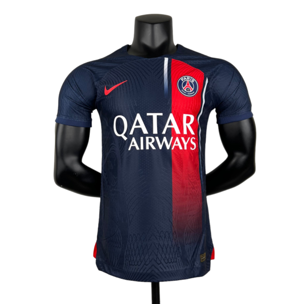 Mannequin wearing a navy PSG football jersey with a red vertical stripe and Qatar Airways sponsor logo on the chest crest visible.