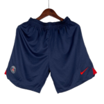 Navy athletic shorts on a wooden hanger with PSG crest on the left thigh and a red Nike swoosh.