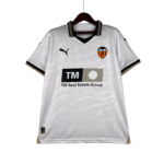 White Valencia CF jersey on a wooden hanger, featuring the club crest on the chest and the Puma logo.