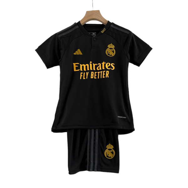 Black Real Madrid soccer jersey on a wooden hanger, featuring gold crest and Emirates Fly Better sponsor.