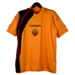 Orange Diadora sports jersey with a black and red diagonal stripe, chest crest, hanging on a hanger.