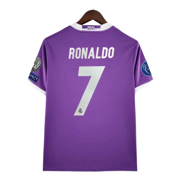 Purple Real Madrid football jersey with 'RONALDO' and the number 7 on the back, hanging on a wooden hanger.