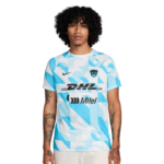 Man wearing a blue and white geometric soccer jersey with DHL and Mifel logos against a white background