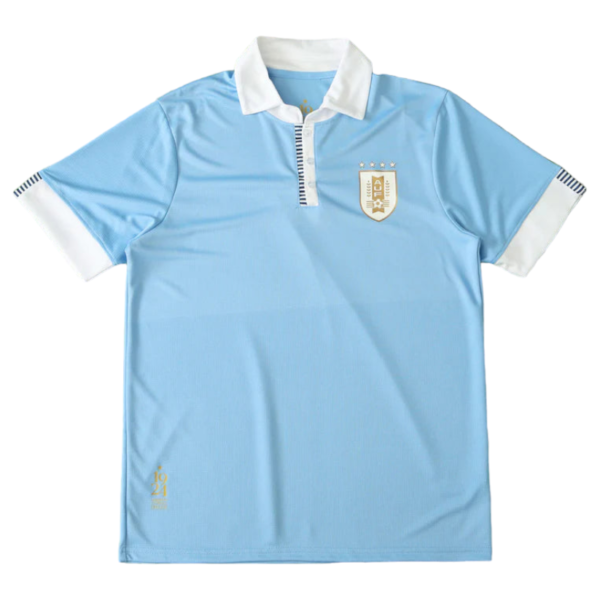 Light blue polo shirt with white collar and cuffs featuring a crest badge on the chest, likely a sports jersey.